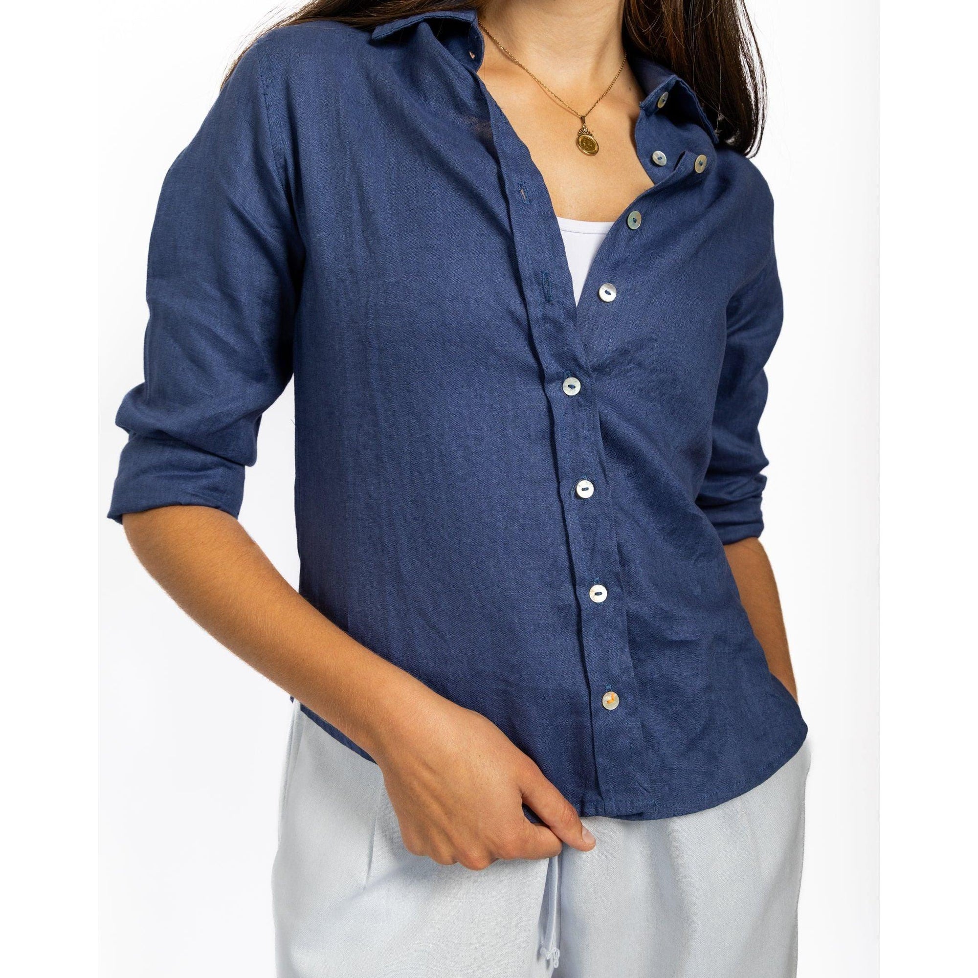 Person wearing a blue button-up shirt with a white background