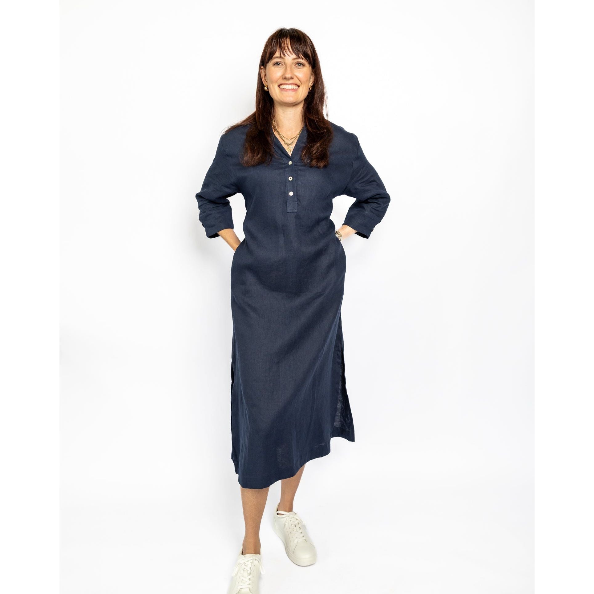 Woman wearing a navy blue dress on a white background