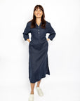 Woman wearing a navy blue dress on a white background