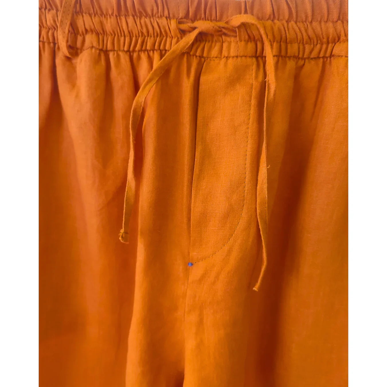 Close-up of orange pants with drawstring waistband